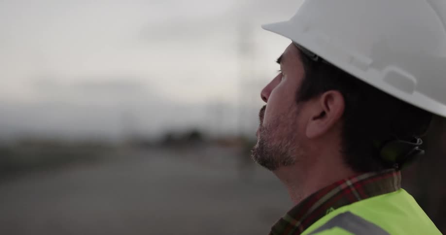 Construction worker out in the field discusses building plans while gesturing