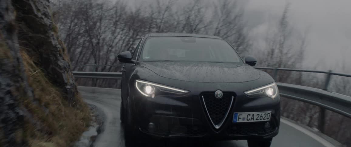 A car travels on the winding mountain road