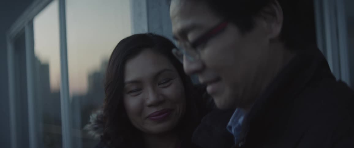 A woman is talking with a man outside and they are smiling