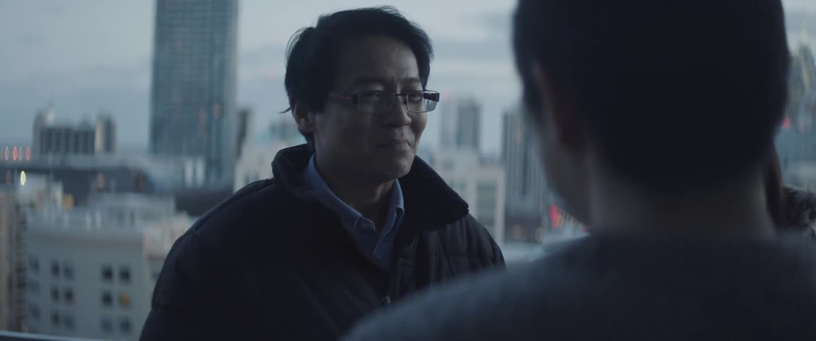 Man greets a surprised looking man and woman