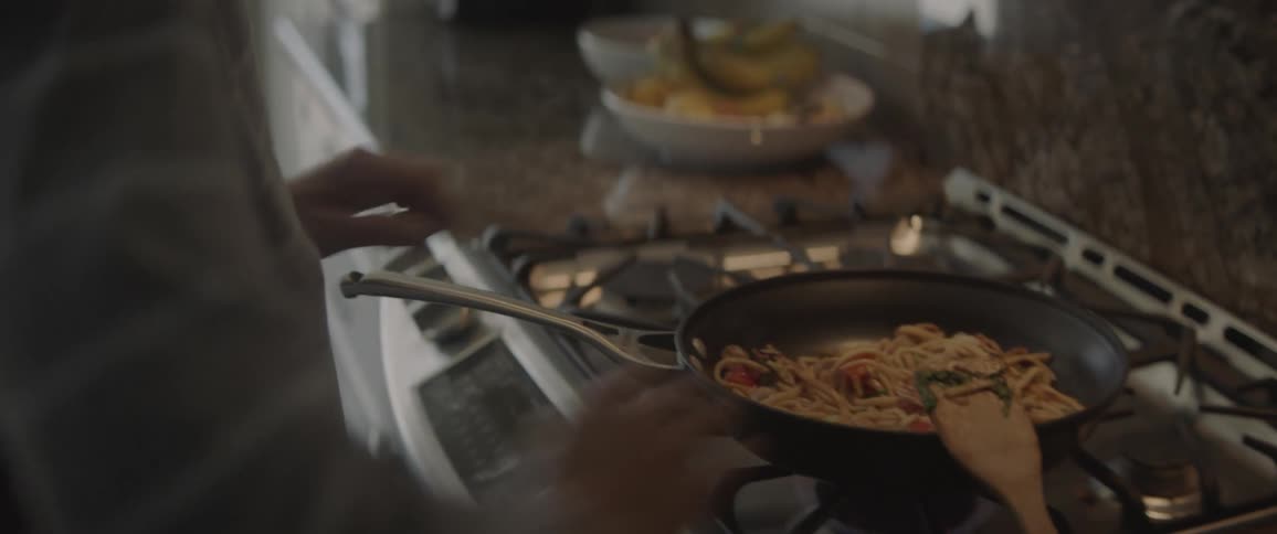 A man is cooking some food on the stove