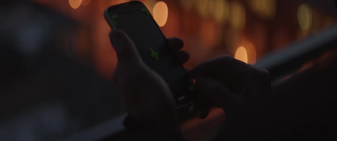 A person is using a phone at night