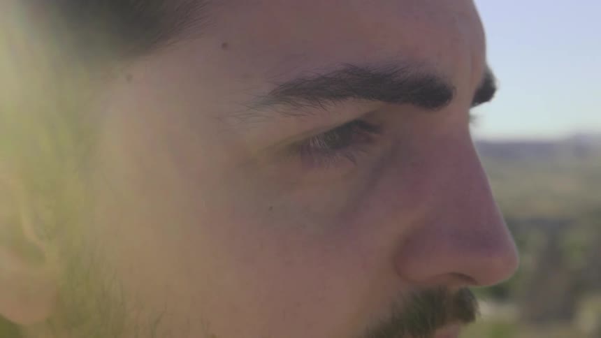The sun shines down on a man