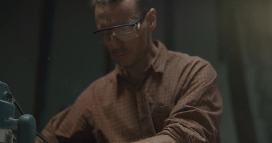 Man wears safety glasses while using heavy power tools
