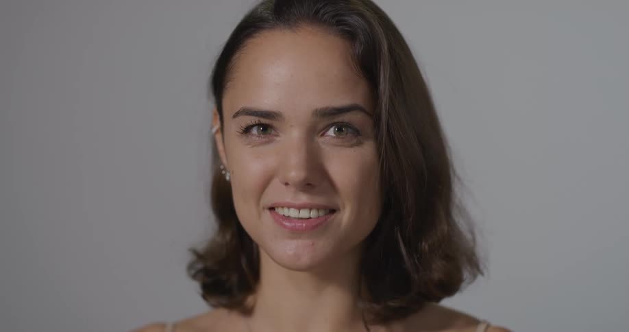 A woman is smiling indoors
