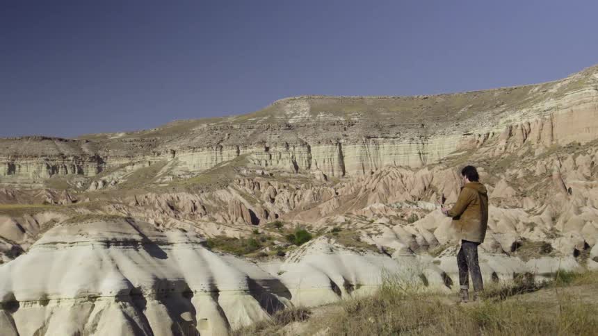 A man overlooks a rocky valley