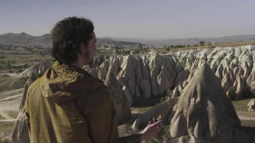 A man overlooks a cluster of rock formations