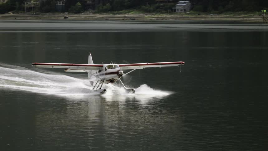 A seaplane skims across the water