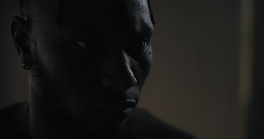 A black man looks away at something with great intensity and focus