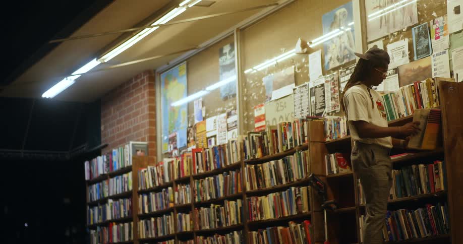 A teenage boy looks at books set up outside a book store