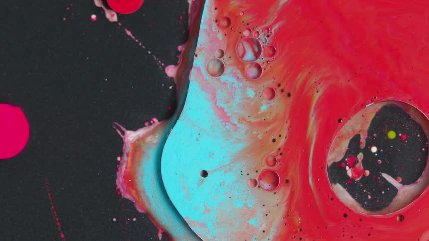 Splatter and drips of liquid moving with shades of redpinkwhite and blue