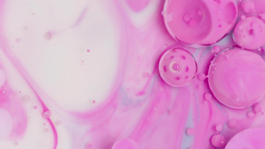 Movement of white and pink paint bubbles
