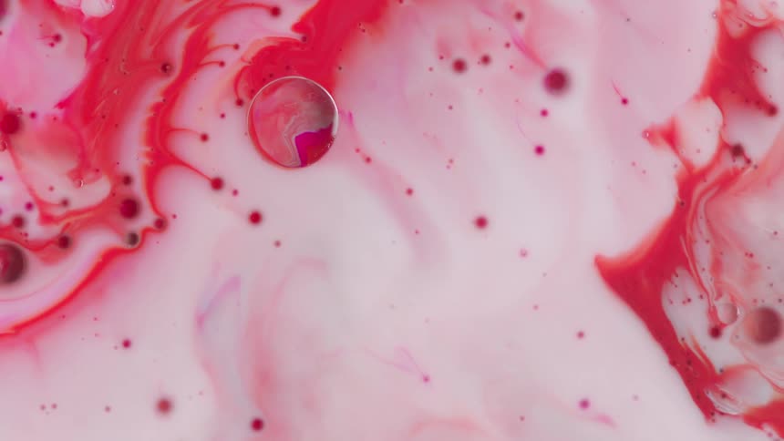 Swirling of white and red paint