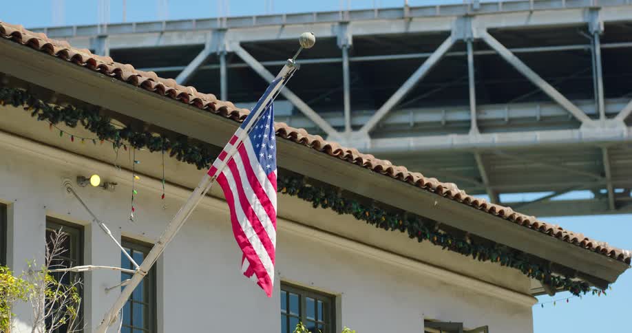A flag waving in a breeze on a building
