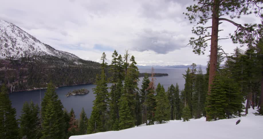 Dark clouds floating above a mountain lake on a winter day