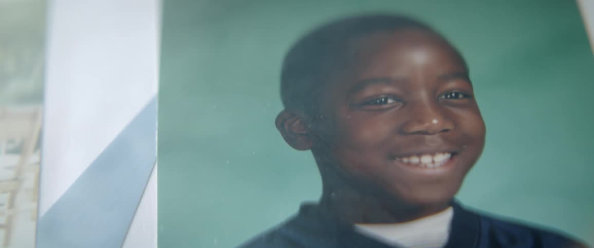 A picture of a young black boy sits on a surface