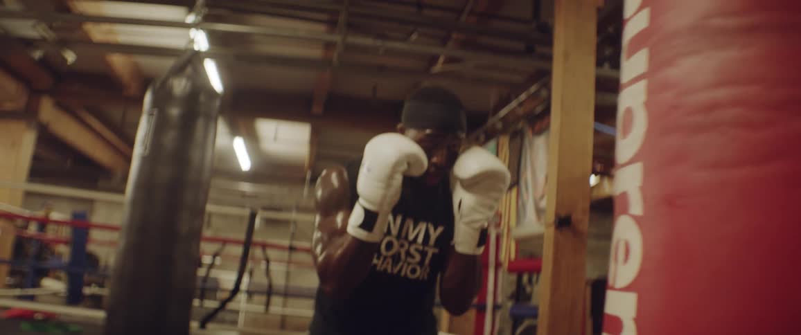 Man hitting a punching bag in a gym