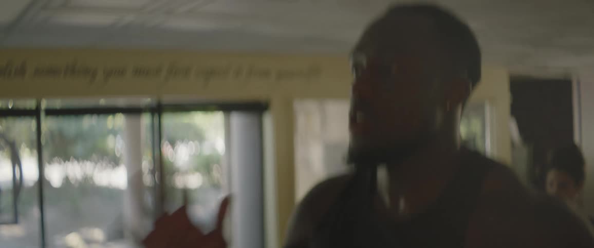 A man is exercising on equipment in a gym