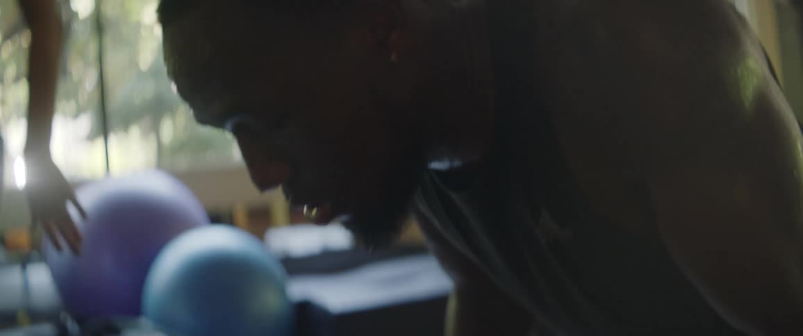 A man sweats while working out at the gym