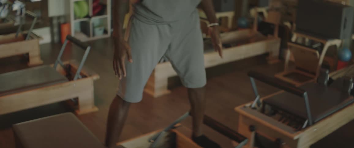 A man lifts his arms while working out in a gym
