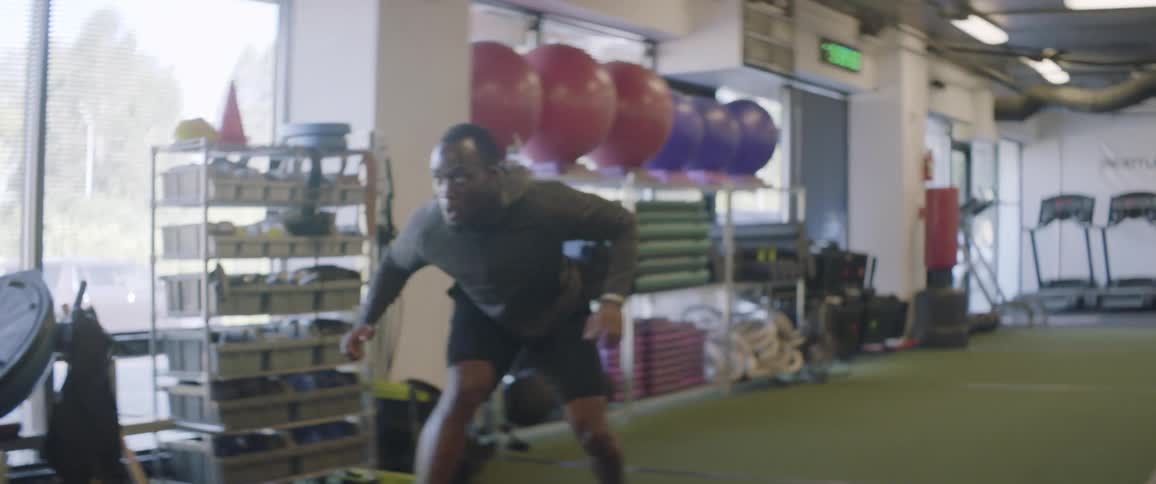 A man goes for a pass in the gym