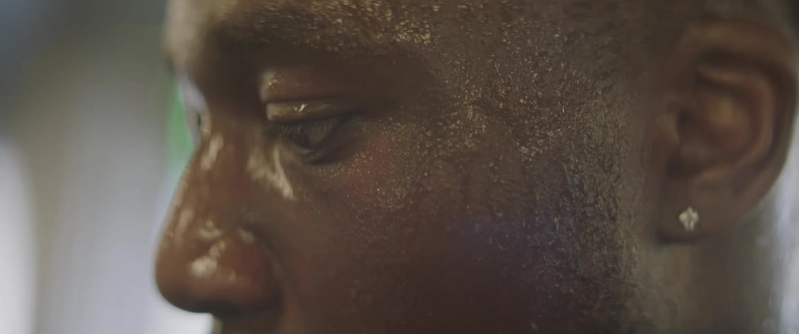 A man is sweating heavily as he looks forward