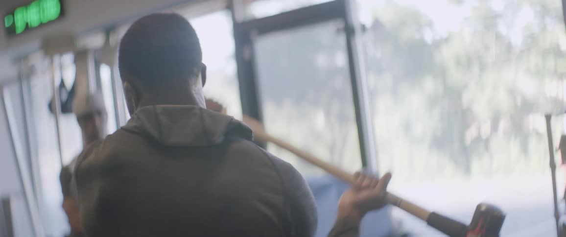 A man in the gym uses a sledgehammer on a tire