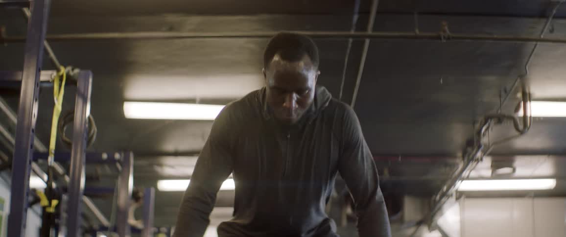 A male athlete is working out using weights on a barbell