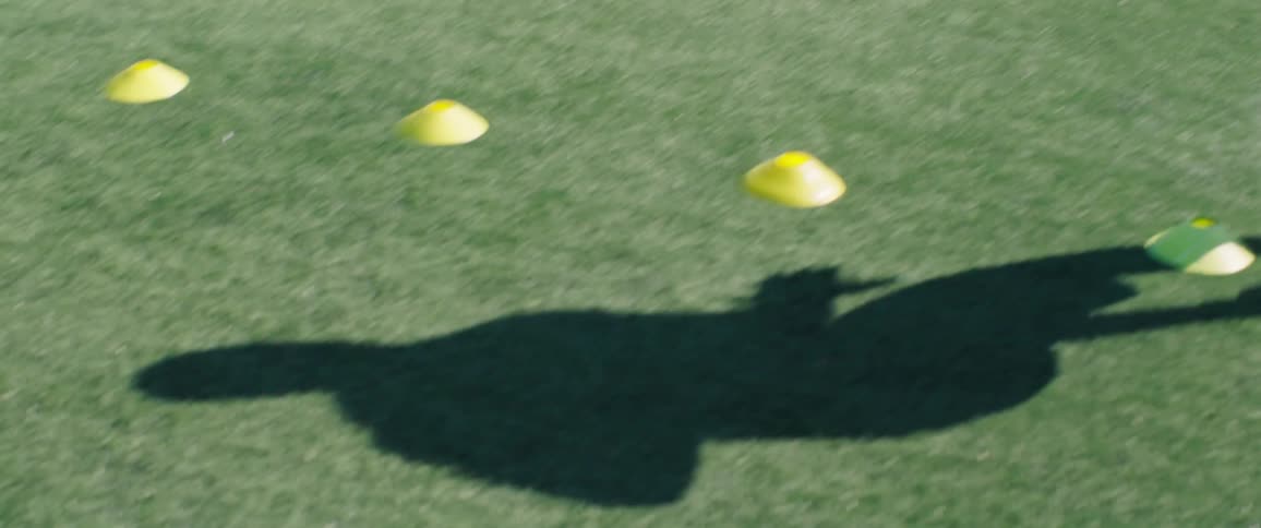 A football player is working on footwork during a training session