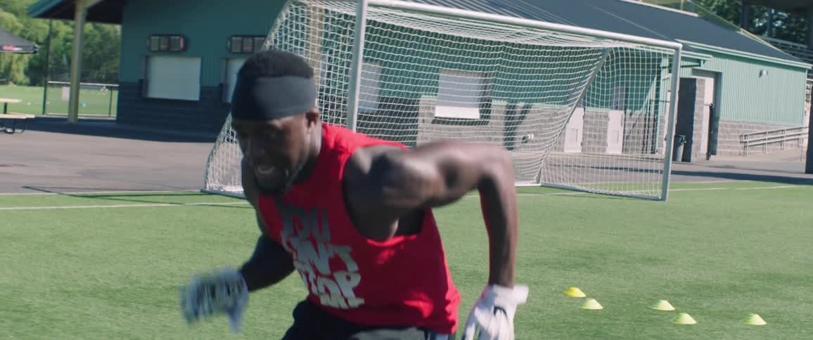A man performs agility drills and catches a football
