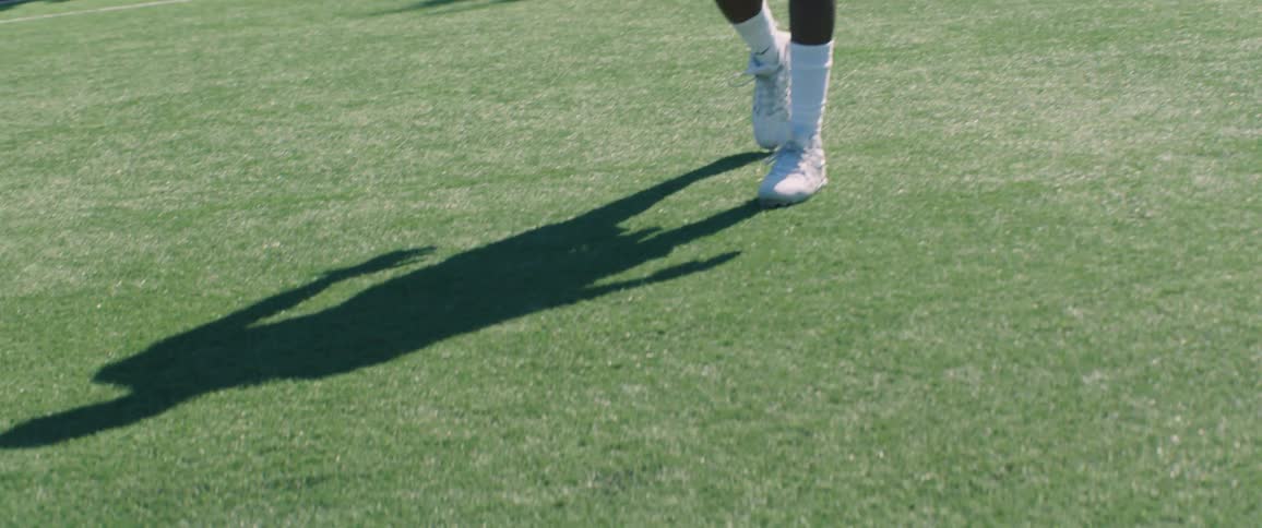 A man walks slowly on the football field