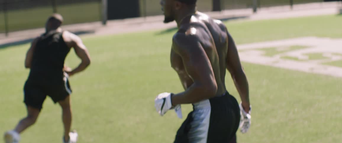 A man is taking a breather before crouching down by others and running
