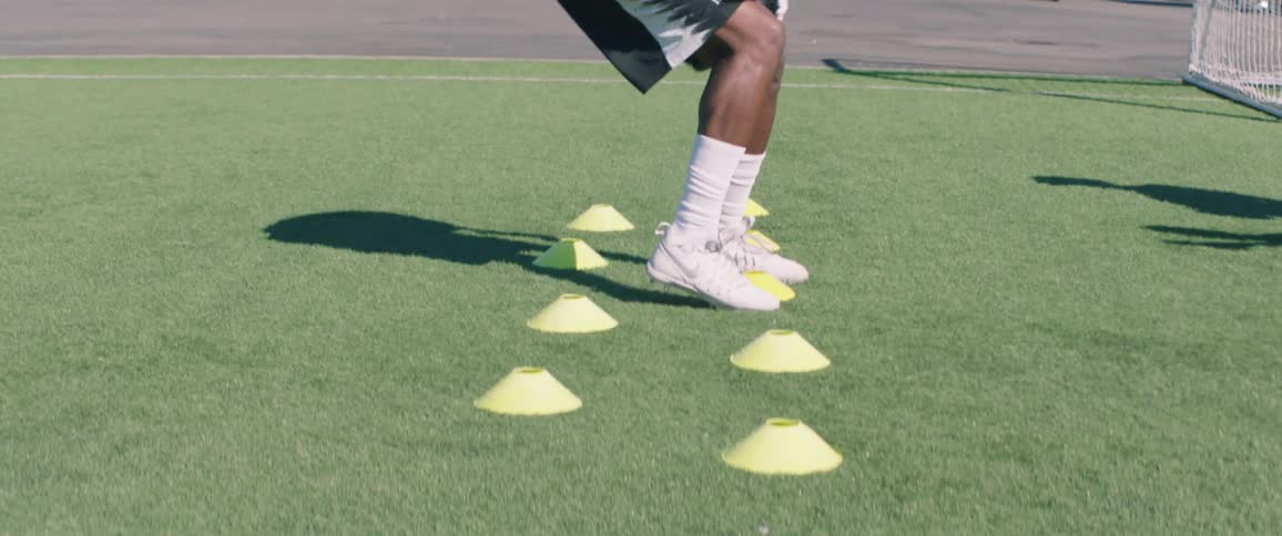 A person practices on a football field