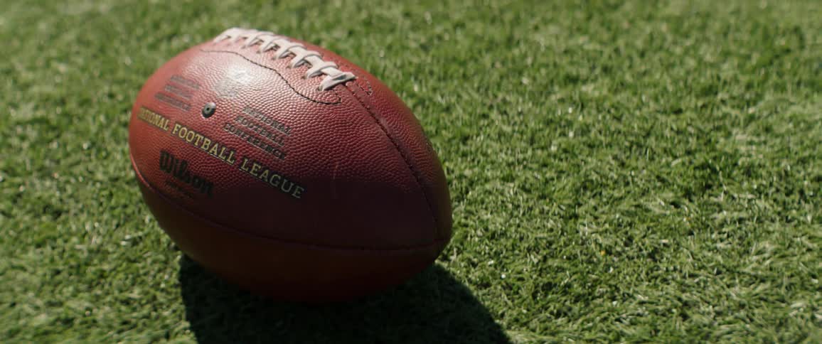 Football on the grass on a sunny day