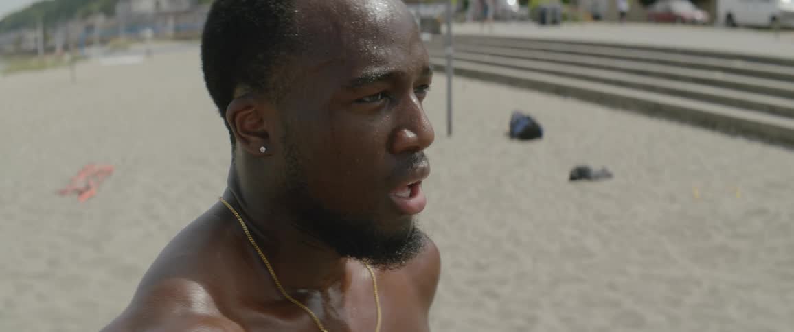 A man breathes heavy sweating on the hot beach