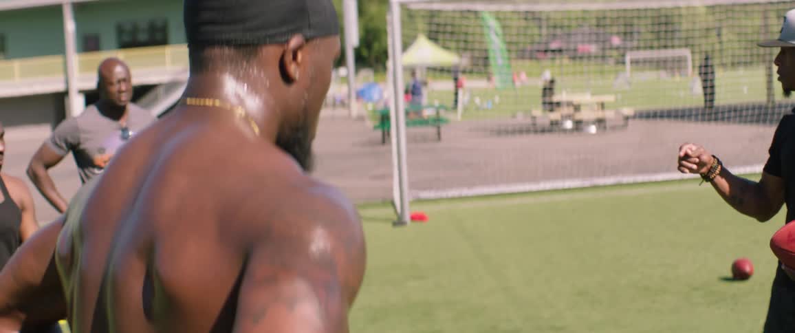 Football players talk on the field together
