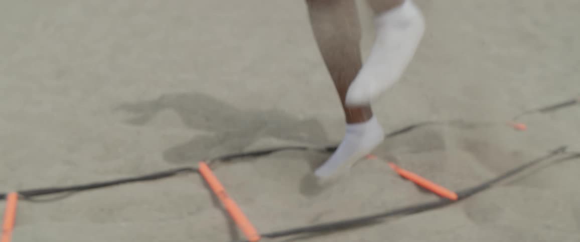 A man runs past a obstacle in socks