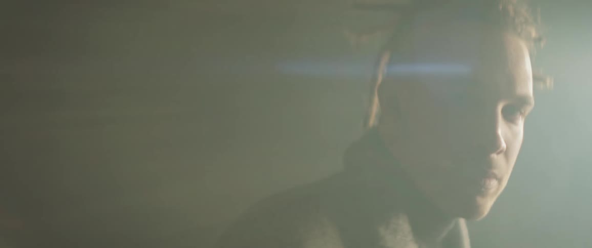 Man stares while a light shines on his face