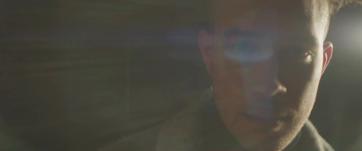 A light shines on a man's head