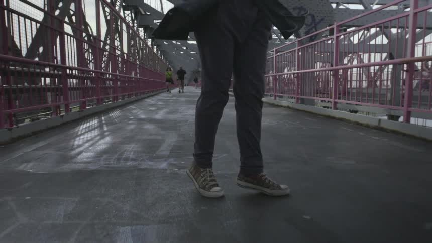 A person is moving across a platform dancing the whole time