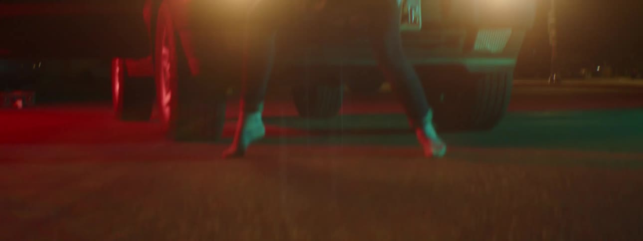 A person dancing outside near a truck