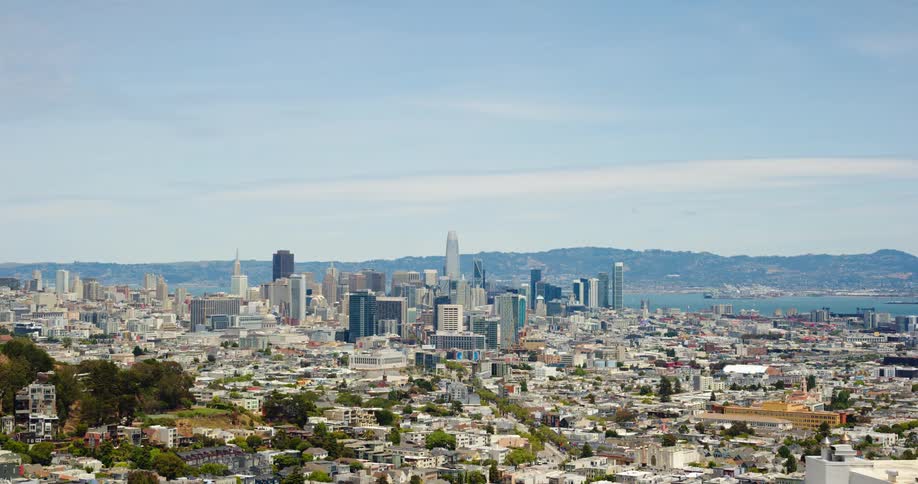 A city skyline with buildings and skyscrapers with the sky and clouds in the background