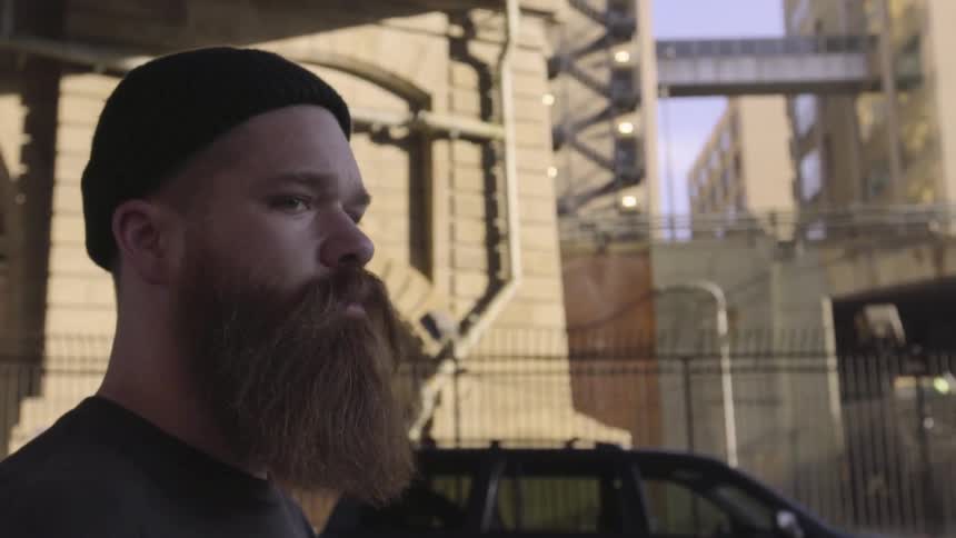 A man with a beard walks
