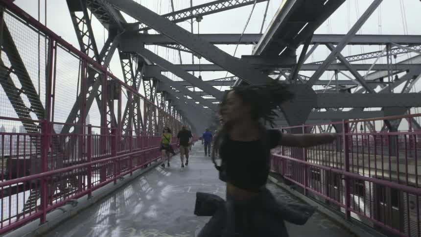 A woman is walking as she dances around