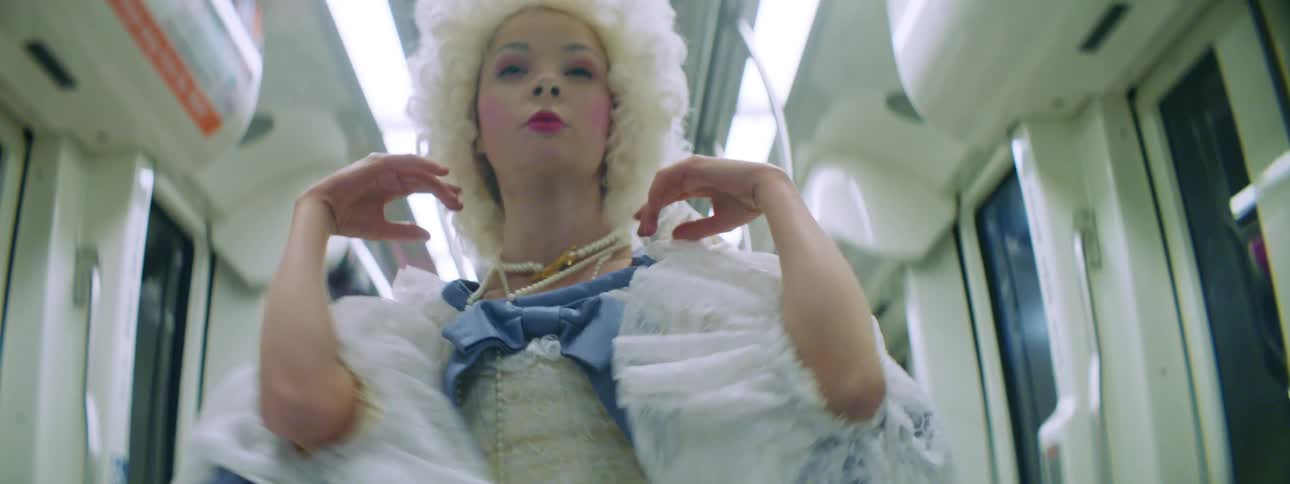 A teenage girl in costume dancing on a bus