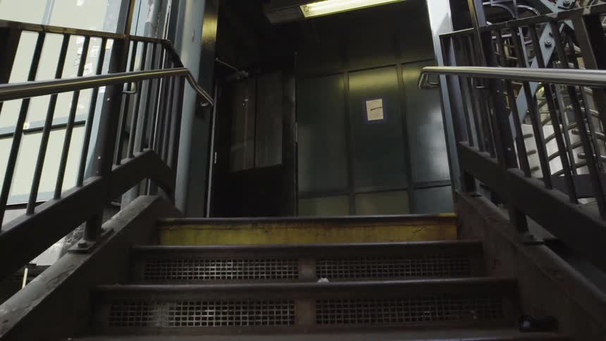 Moving up some steps towards a glass door