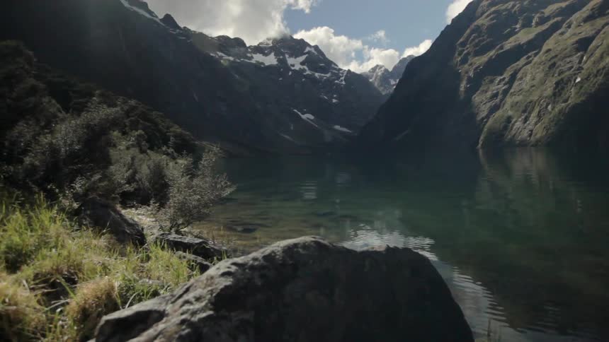 A lake between mountains during the day time