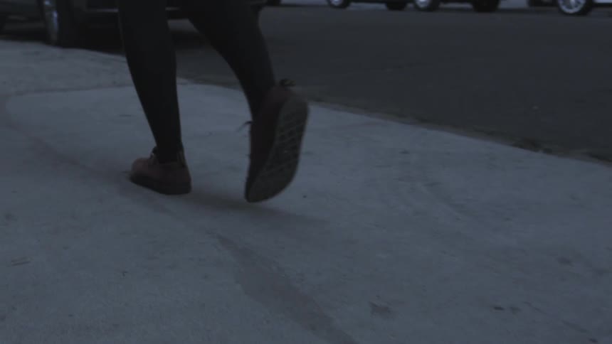 Female feet walking in flat shoes in an urban area