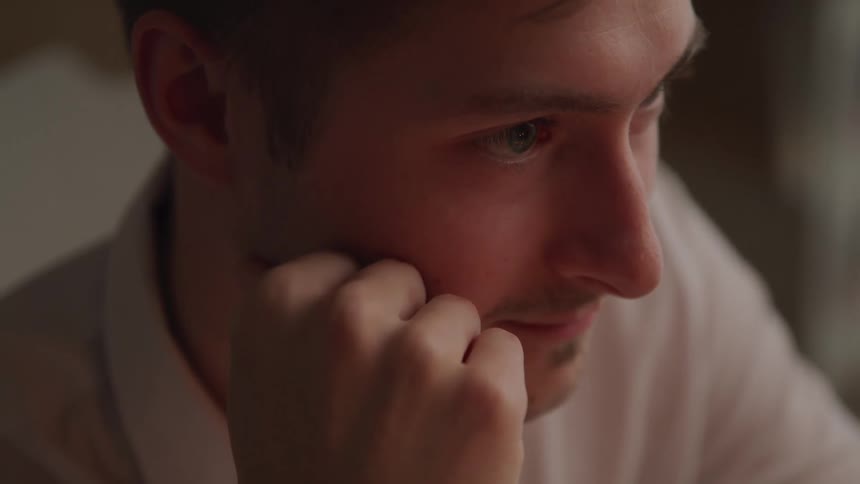 A man is smiling in a room