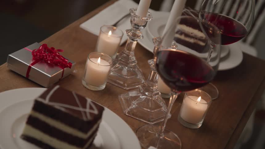 A table with dessert wine candles and a gift